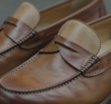 Classic two-tone penny loafers with brown and tan leather.