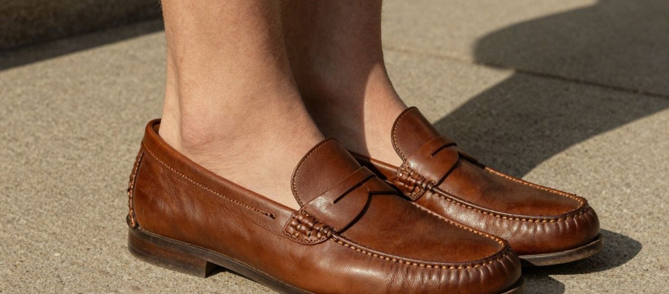 Man wearing penny loafers sockless in summer.