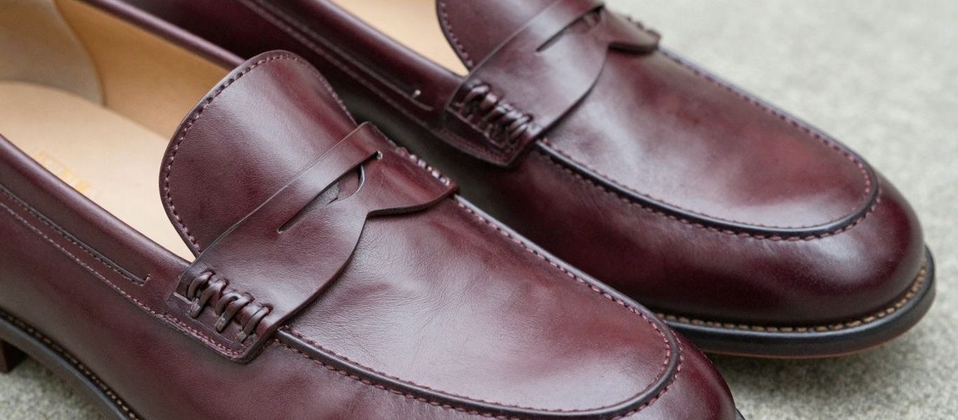Classic cordovan penny loafers, polished leather dress shoes.