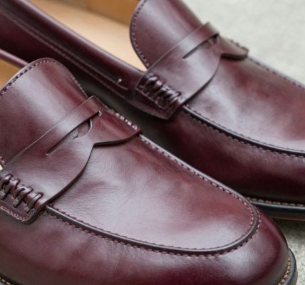 Classic cordovan penny loafers, polished leather dress shoes.