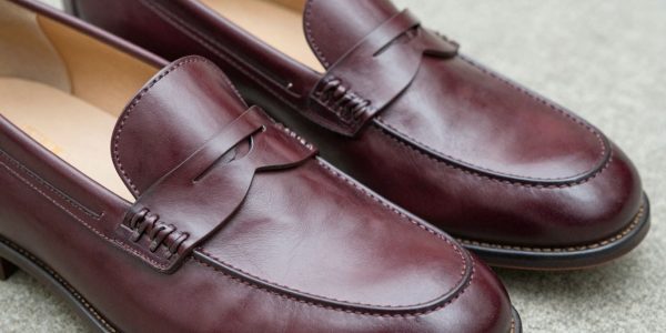Classic cordovan penny loafers, polished leather dress shoes.