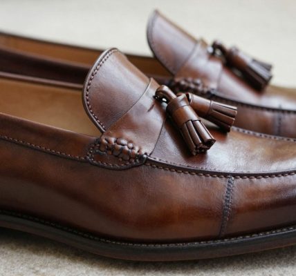 Brown leather tassel loafers for a wedding guest.