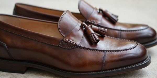 Brown leather tassel loafers for a wedding guest.