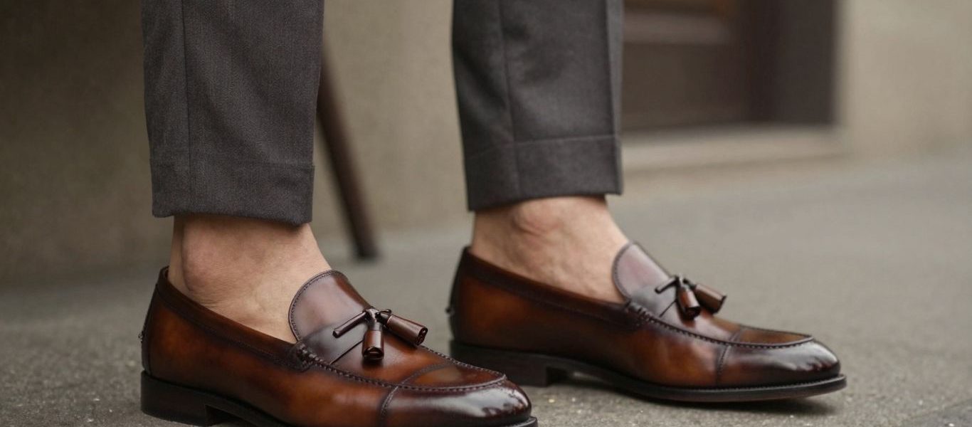 Man wearing tassel loafers with a suit.