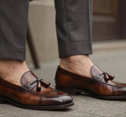 Man wearing tassel loafers with a suit.