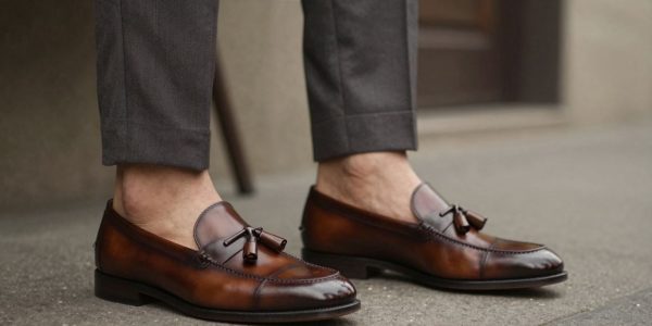 Man wearing tassel loafers with a suit.