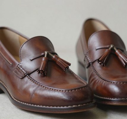 Brown leather tassel loafers, perfectly fitted.