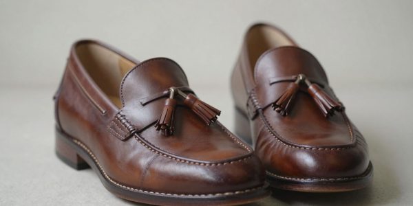 Brown leather tassel loafers, perfectly fitted.