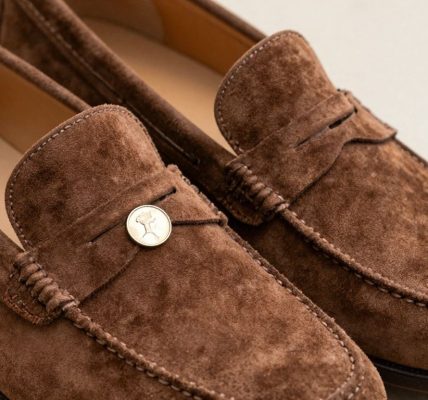 Brown suede penny loafers with a classic design.
