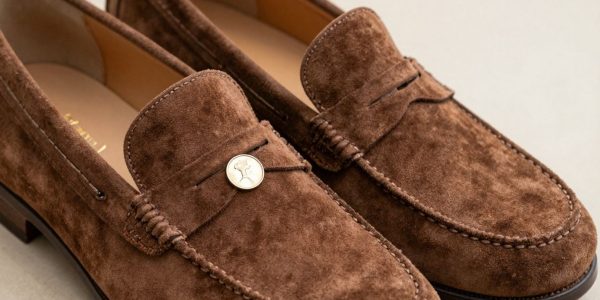Brown suede penny loafers with a classic design.